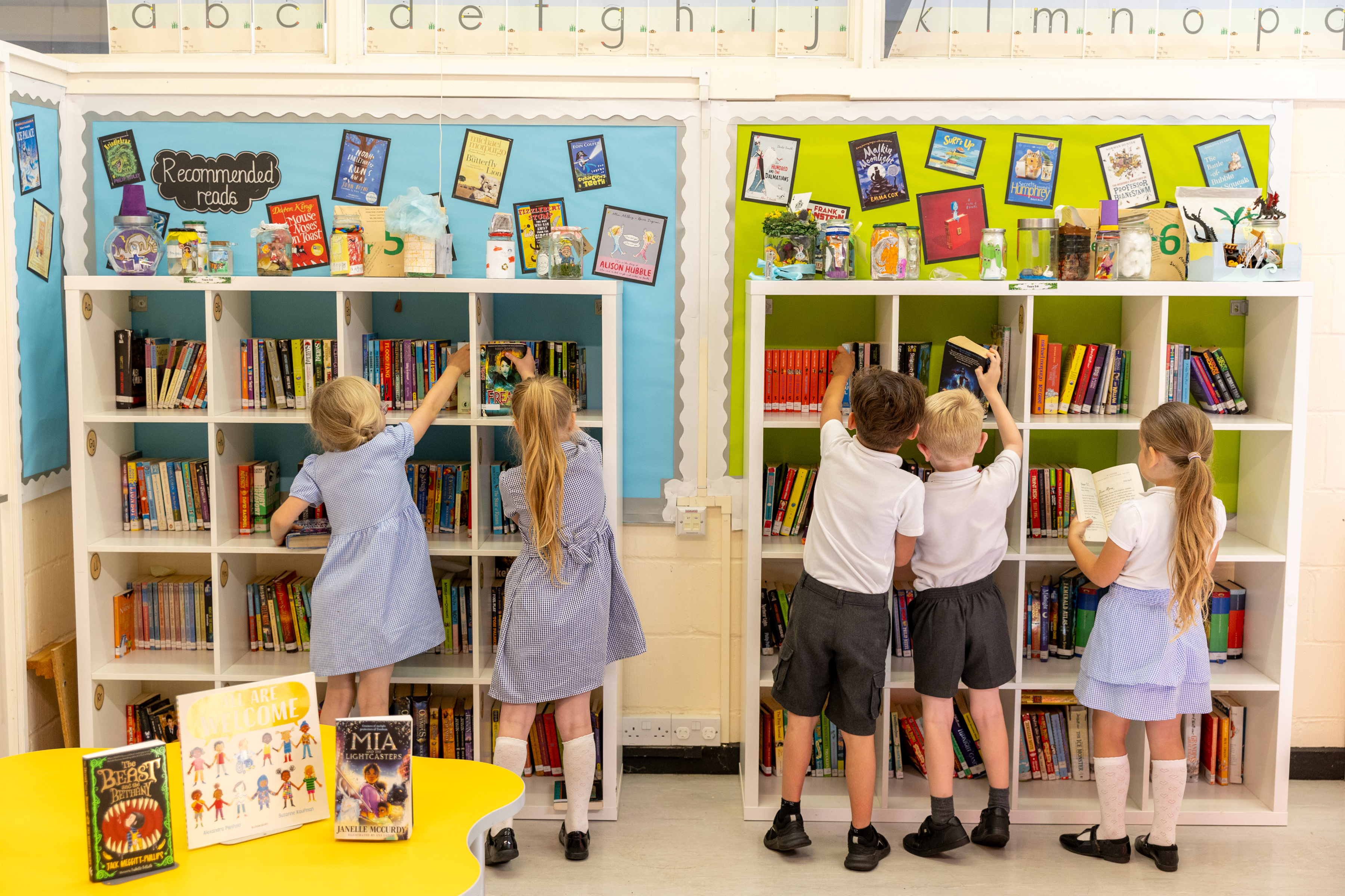 A teacher helping year 2 students with their work at Staplehurst School.