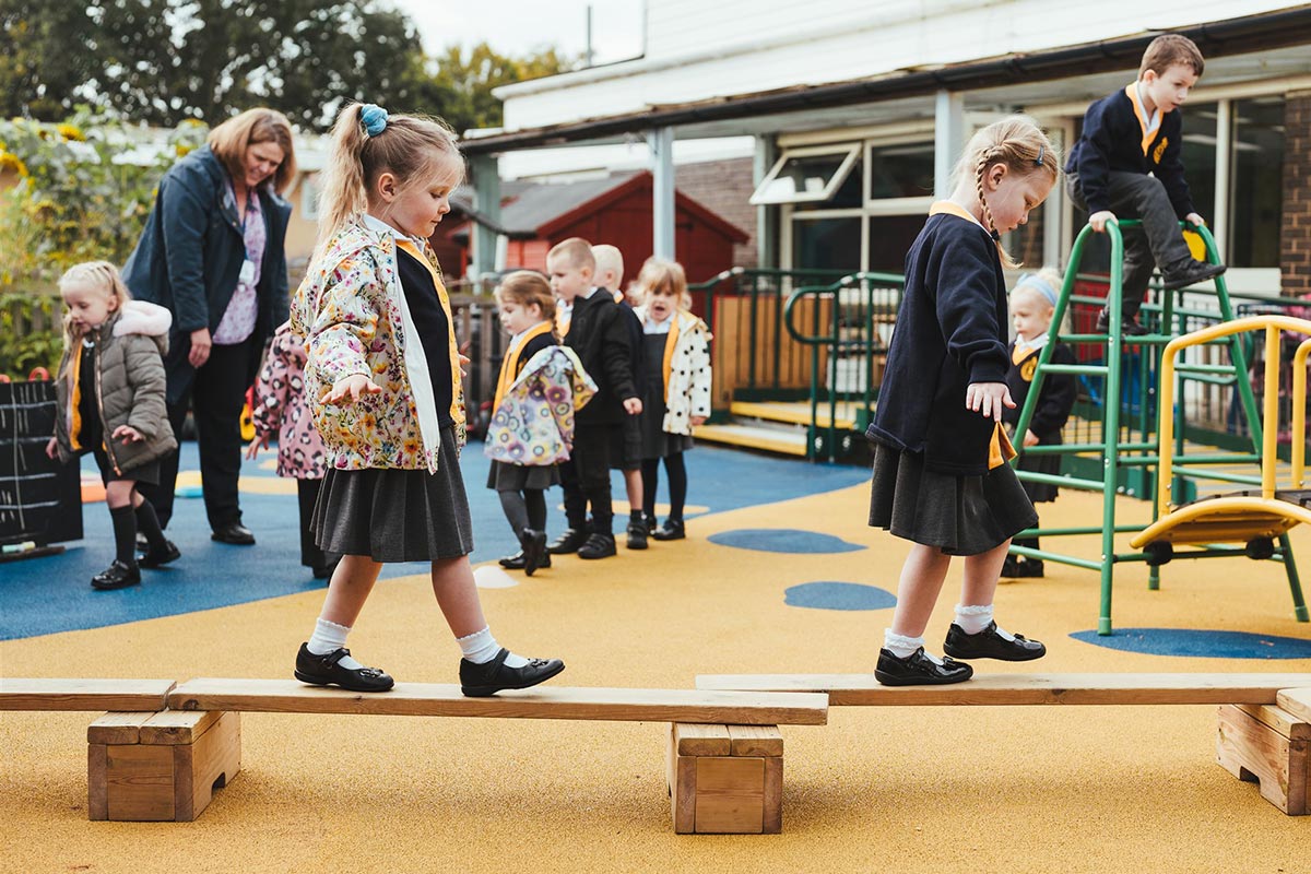 Staplehurst School playground, with children using the playing equipment.